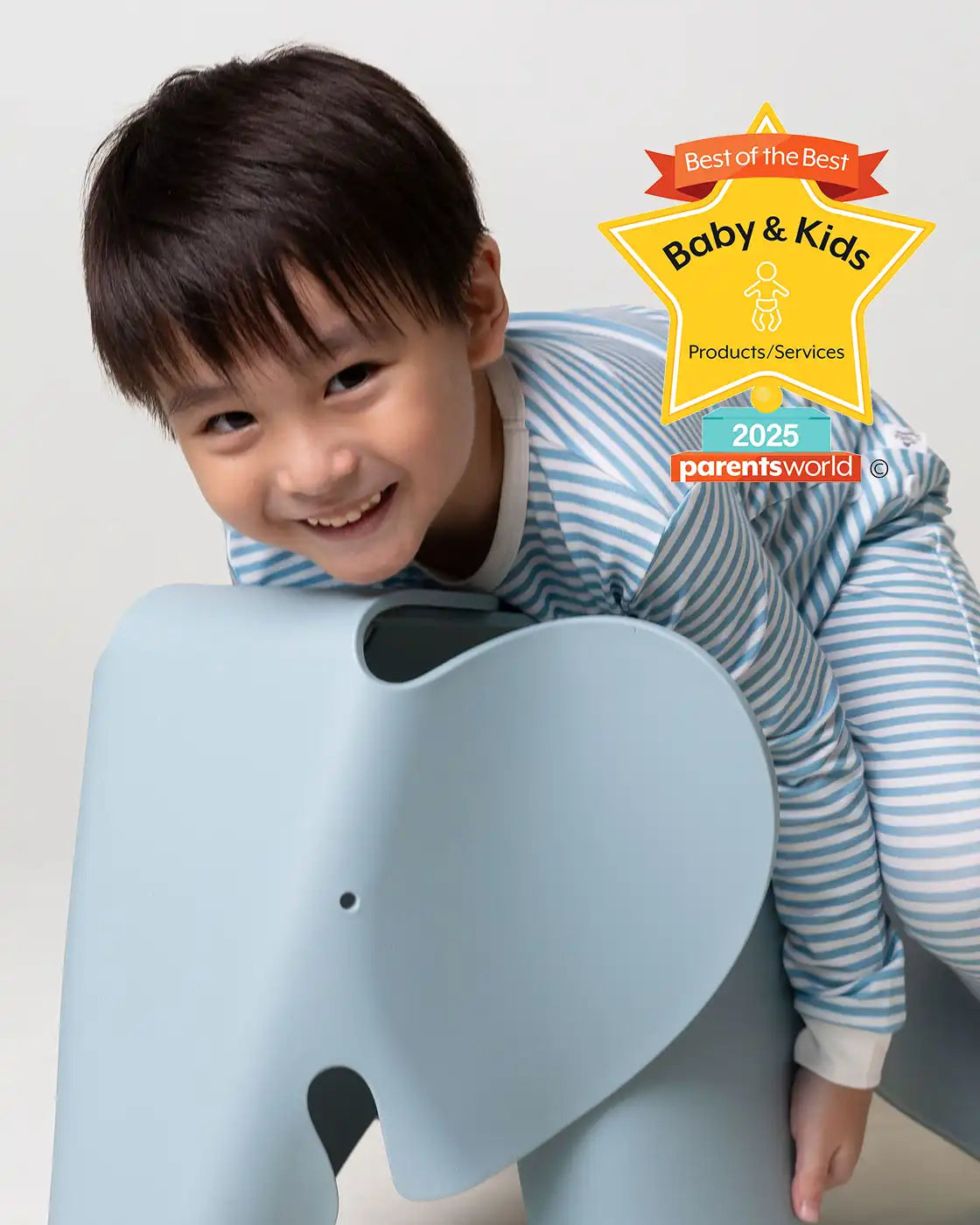 Boy wearing blue stripe pajamas with Parents World Magazine Award 2025 Winner for Best in Ultra-Soft & Durable Kids Sleepwear