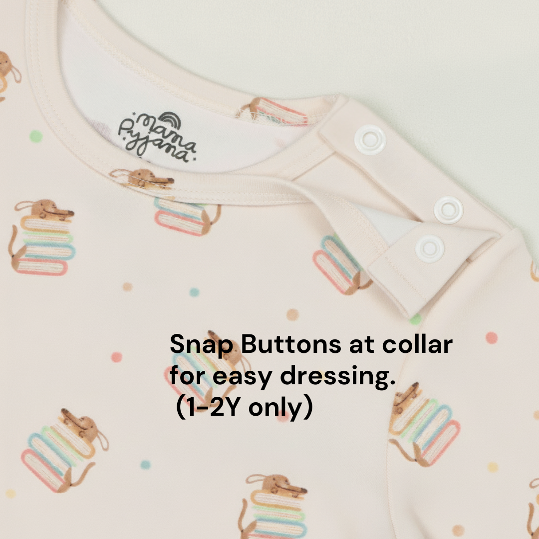 Beige pyjama top with pup hiding behind story book. Snap buttons at collar for easy dressing for 1-2Y sizes